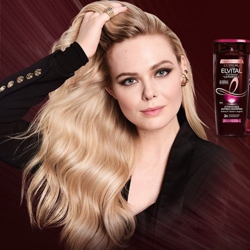 Elvital Full Resist Produktreihe mit Elle Fanning, die sich durch ihr Haar fährt