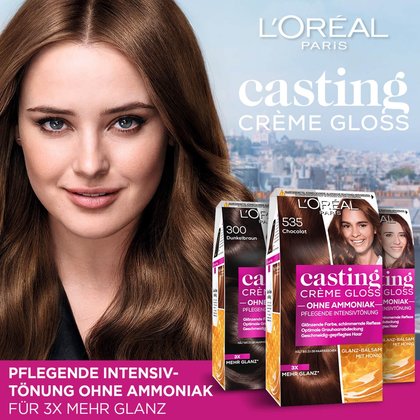 Drei Casting Creme Gloss Verpackungen und eine Frau im Hintergrund eine Stadt